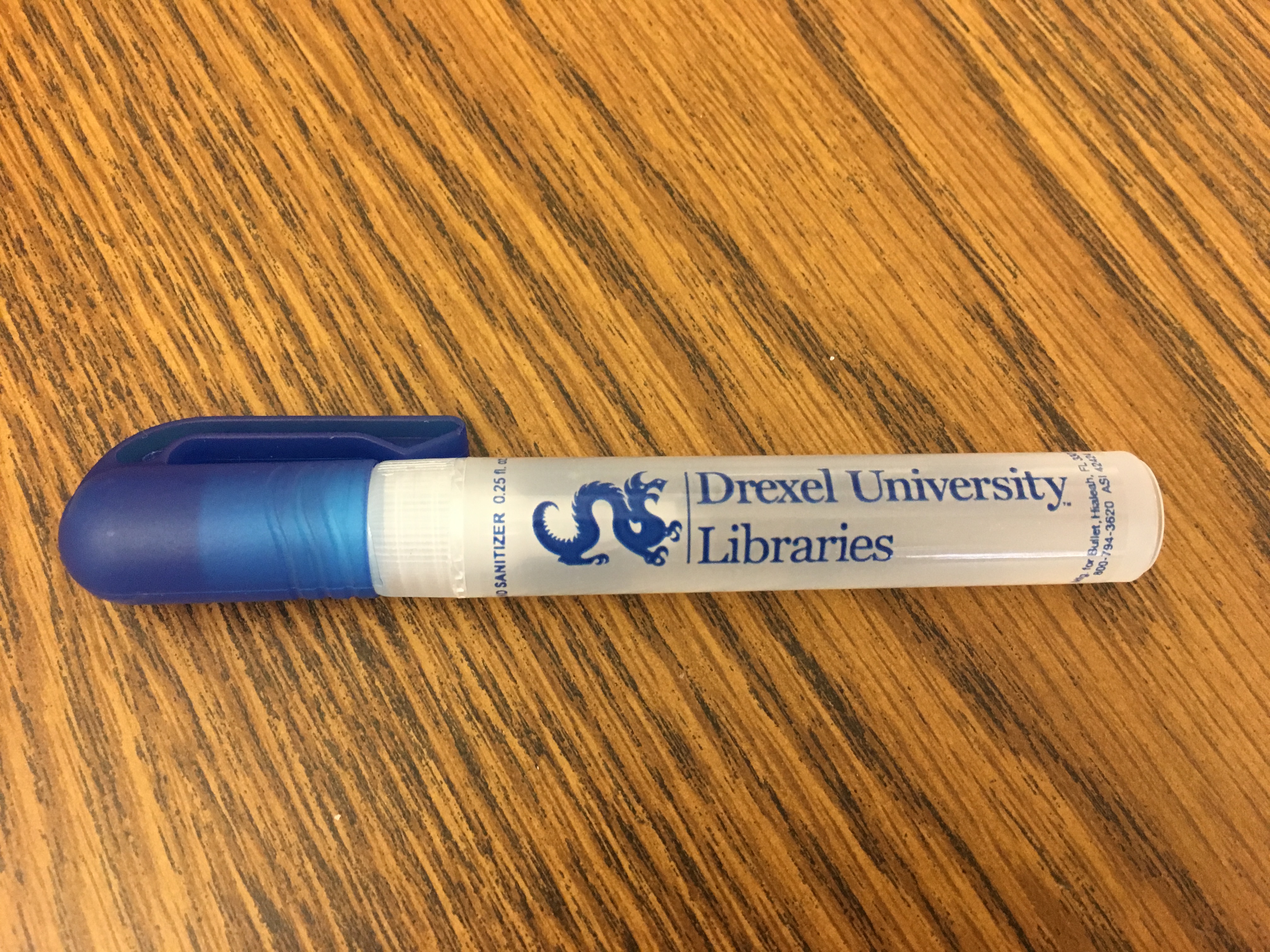 Hand sanitizer pen with the Drexel Libraries logo